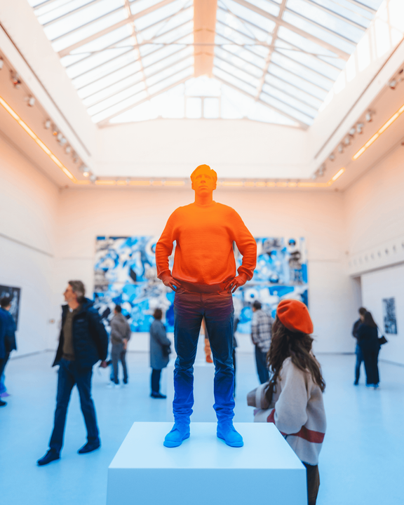 A photo showing a crowded museum room